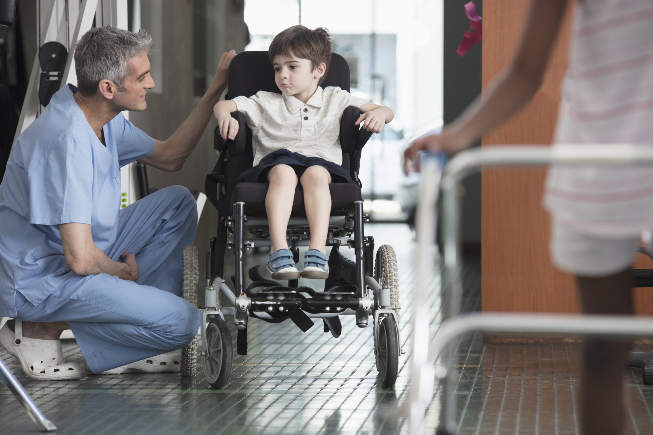 Healthcare professional supporting a child in a hospital setting