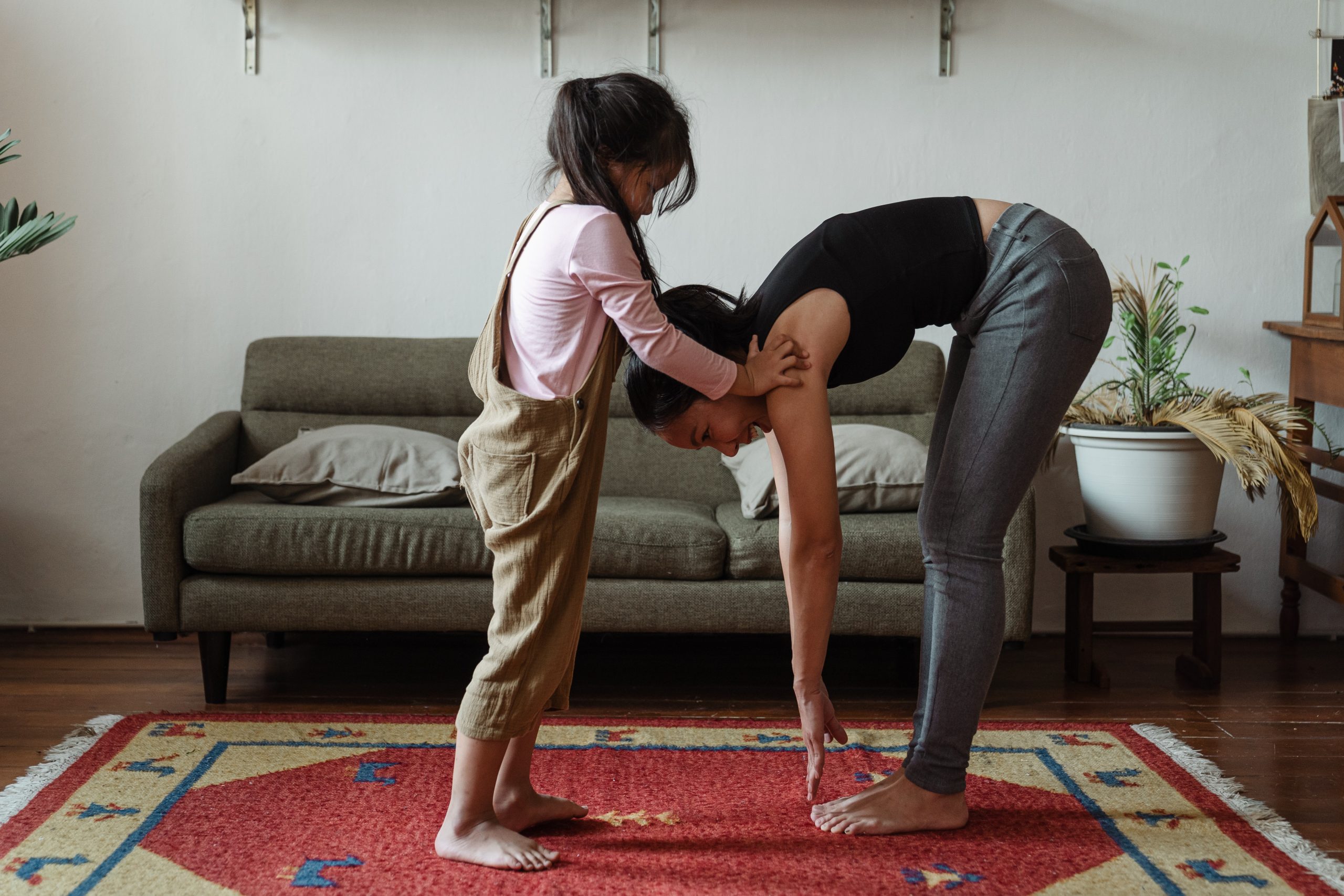 Parent and child practicing movement together at home